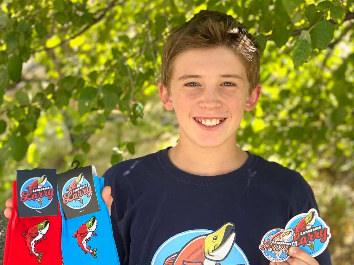 Topher Jones displays Lonesome Larry merchandise